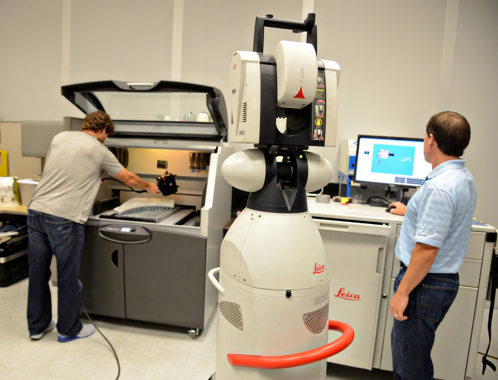 Todd Bayles and Nathan Pitkovich, mechanical engineers in the 76th Commodities Maintenance Group’s Reverse Engineering and Critical Tooling (REACT) office, use a Leica laser tracker, a 3-D scanner, on a seal retainer prototype for CAD verification. 3-D printing, or additive manufacturing, is a relatively new technology that Tinker’s engineers are in the forefront of helping to revolutionize. (Air Force photo by Kelly White/Released)