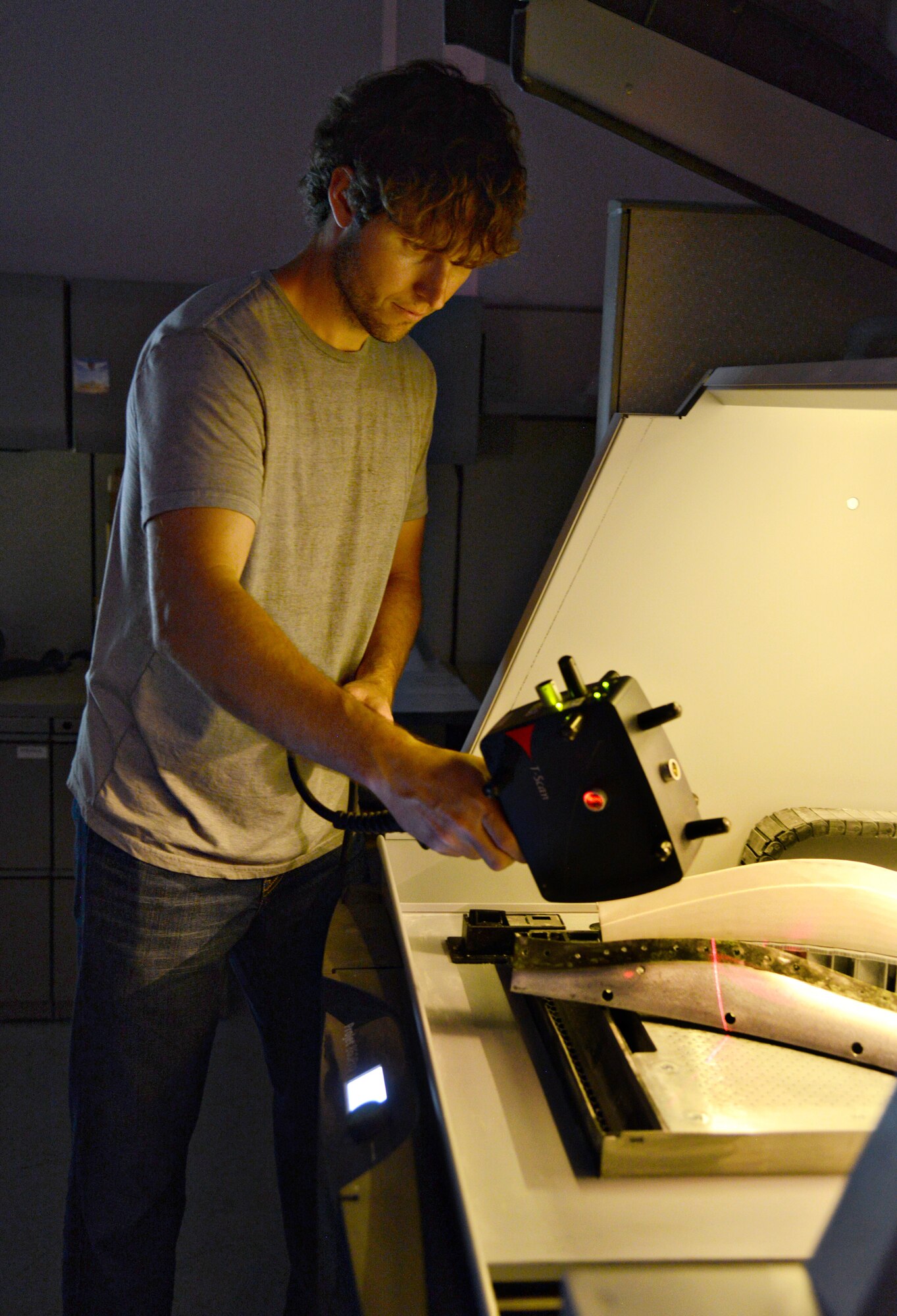 Todd Bayles, a mechanical engineer in the 76th Commodities Maintenance Group’s REACT office, uses a Leica laser tracker on a seal retainer prototype for JSTARS for CAD verification. (Air Force photo by Kelly White/Released)