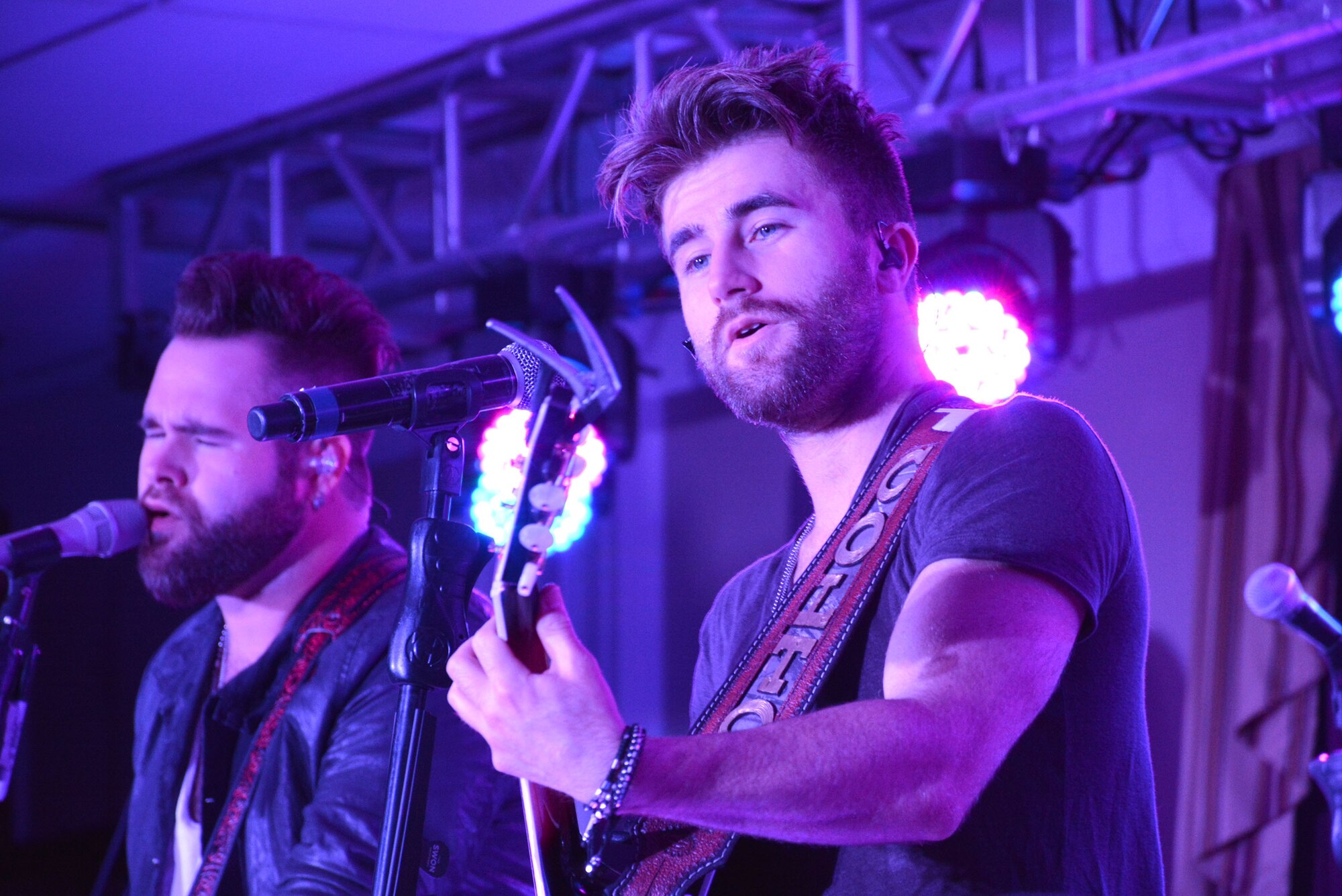 The Swon Brothers, Colton, right, and Zach, perform for an appreciative crowd Oct. 7 at the Tinker Club as part of a USO tour that made a stop at Tinker Air Force Base. The Swon Brothers and their crew also toured an E-3 “Sentry” Airborne Warning and Control System aircraft earlier in the day. In 2013, the American country music duo from Muskogee finished in third place on the fourth season of NBC’s “The Voice,” making them the first duo to make it from the Top 12 live shows to the season finale. (Air Force photo by Darren D. Heusel/Released)