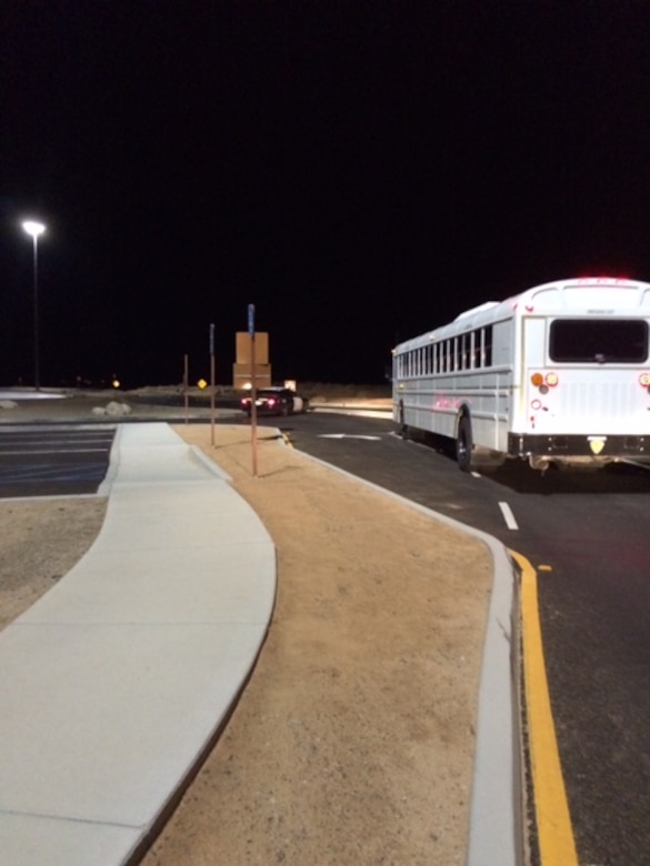 An Edwards AFB bus heads out the gate early in the morning escorted by California Highway Patrol Oct. 16. Local authorities contacted the base asking for assistance to help motorists who were stranded by a mudslide on SR 58 east of Tehachapi. Heavy rainstorms hit the Antelope Valley on the evening of Oct. 15 causing mudslides, flooding and road closures. (Courtesy photo)