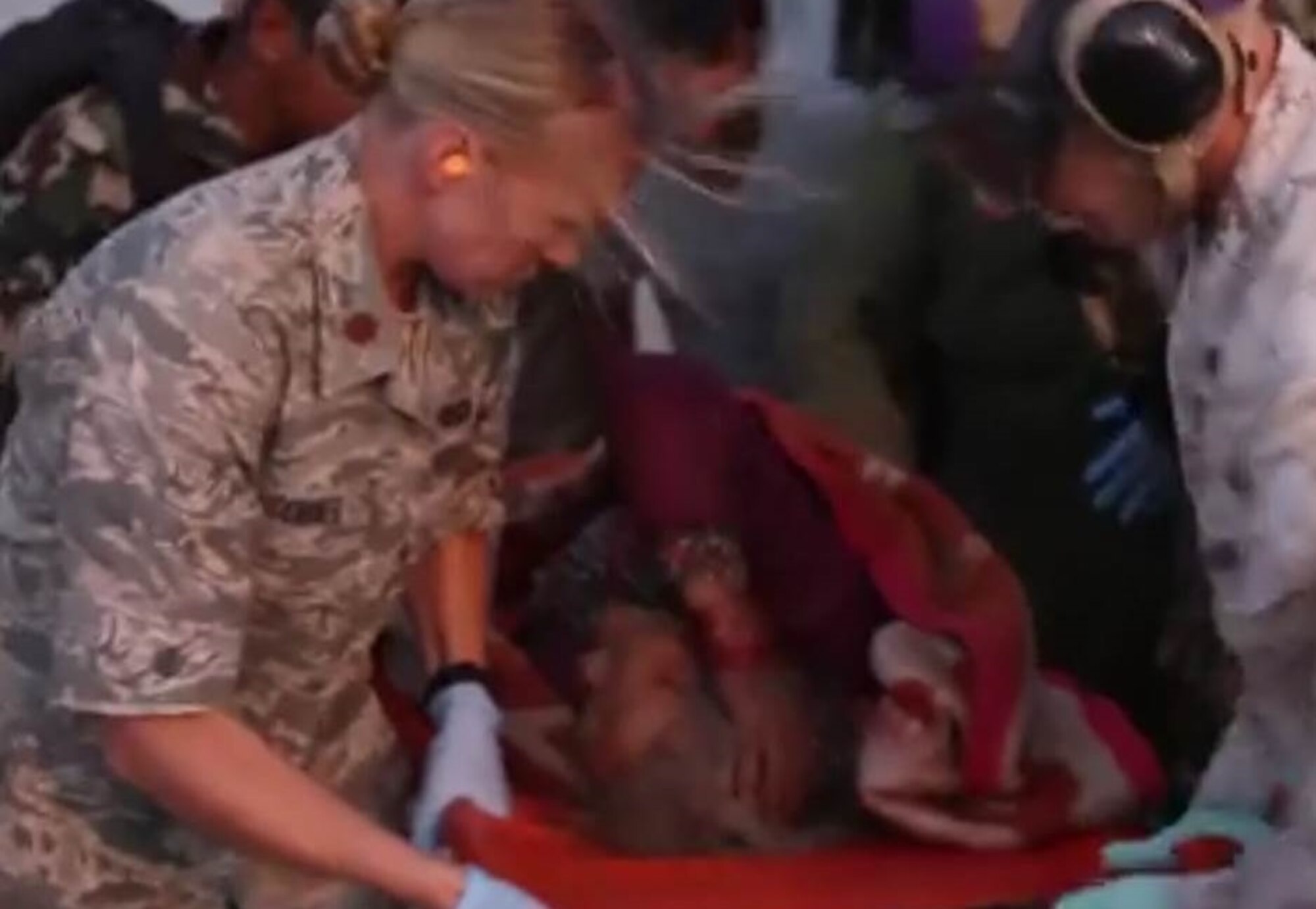 Maj. Ashley Conner along with U.S. Service members with Joint Task Force 505 and humanitarian aid organization workers unload an earthquake victim from an MV-22 Osprey at a medical triage area at Tribhuvan International Airport, Kathmandu, Nepal, after a 7.3 magnitude earthquake struck the country, May 12. JTF 505 along with other multinational forces and humanitarian relief organizations are currently in Nepal providing aid after a 7.8 magnitude earthquake struck the country, April 25. At Nepal’s request the U.S. government ordered JTF 505 to provide unique capabilities to assist Nepal. (U.S. Marine Corps photo by MCIPAC Combat Camera Staff Sgt. Jeffrey D. Anderson/Released) 
