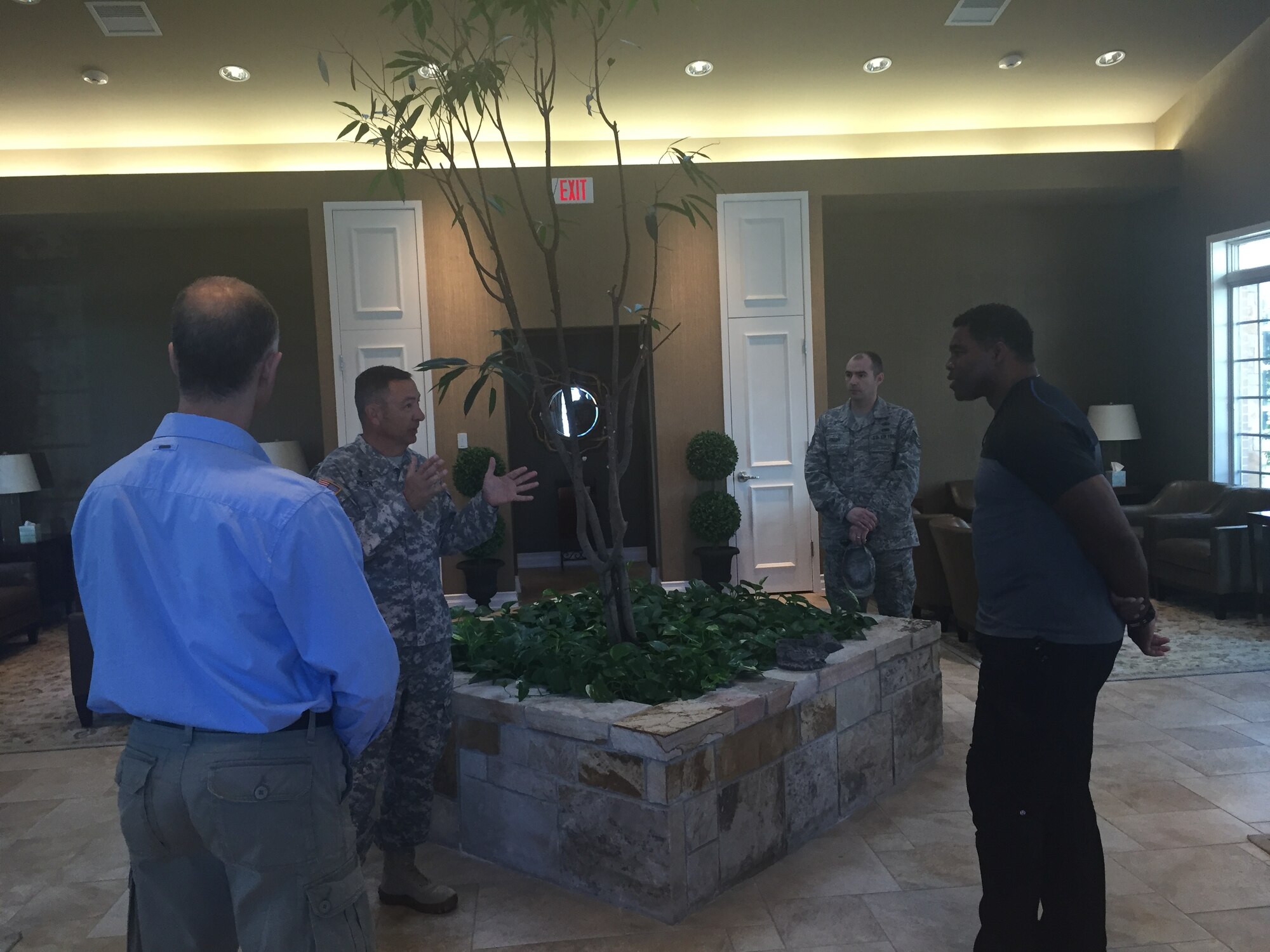 Army Chaplain (Col.) Scott Jensen, briefs former NFL player, Herschel Walker and actor Jeff Gendelman, in the meditation pavilion near the Fisher House for Families of the Fallen, Oct. 15, 2015 at Dover Air Force Base, Del. The chaplain explained their role in supporting families of the fallen. (U.S. Air Force photo/Christin Michaud)