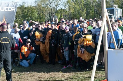 COATESVILLE, Penn. - The Golden Knights pose for a picture with a beginning wave of Tough Mudders after jumping during Tough Mudder Philly in Coatesville, Penn., Oct. 17. The U.S. Army Reserve was one of the sponsors for the event. (U.S. Army photo by Staff Sgt. Debralee Best)