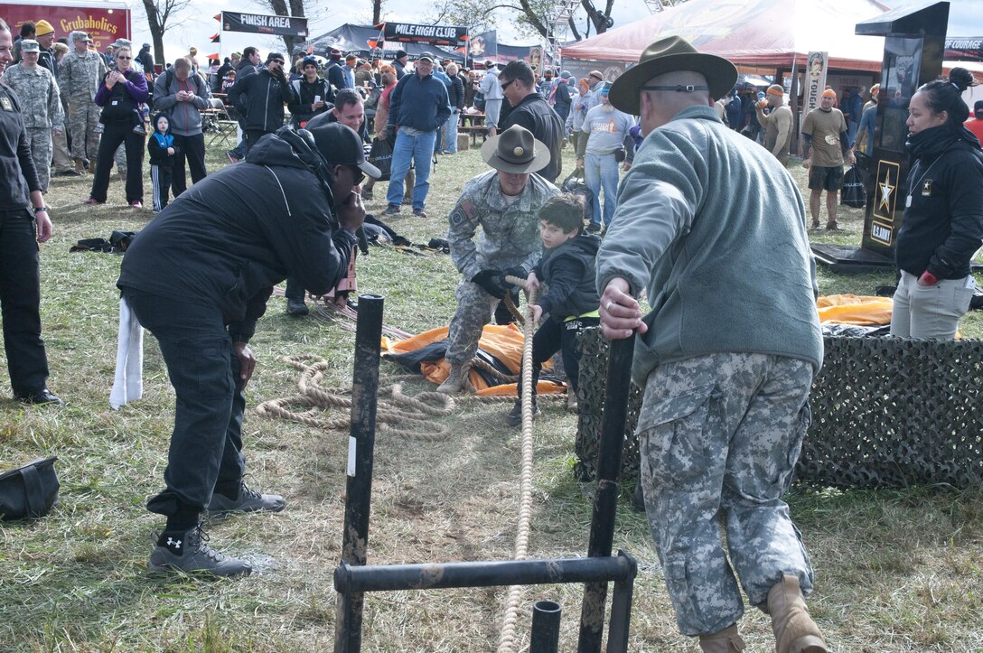 COATESVILLE, Penn. - Drill sergeants with 3rd Battalion, 385th Regiment, assist Jack, 6, in completing the Army Reserve physical fitness challenge during Tough Mudder Philly in Coatesville, Penn., Oct. 17. The U.S. Army Reserve was one of the sponsors for the event.(U.S. Army photo by Staff Sgt. Debralee Best)