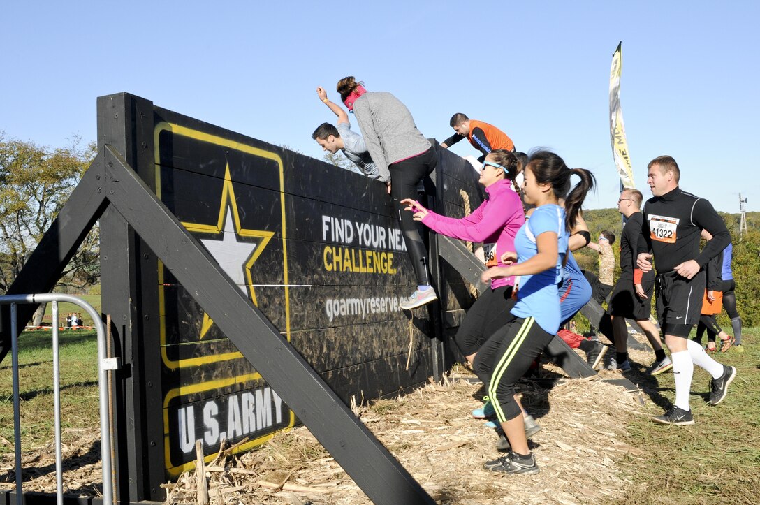 COATESVILLE, Penn. - Tough Mudders climb a wall before beginning the Tough Mudder Philly course Oct. 17 in Coatesville, Penn. The U.S. Army Reserve was one of the sponsors for the event. (U.S. Army photo by Staff Sgt. Bradley Miller)