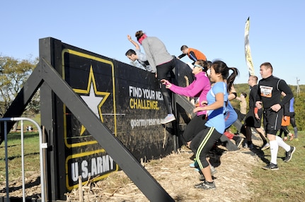 COATESVILLE, Penn. - Tough Mudders climb a wall before beginning the Tough Mudder Philly course Oct. 17 in Coatesville, Penn. The U.S. Army Reserve was one of the sponsors for the event. (U.S. Army photo by Staff Sgt. Bradley Miller)