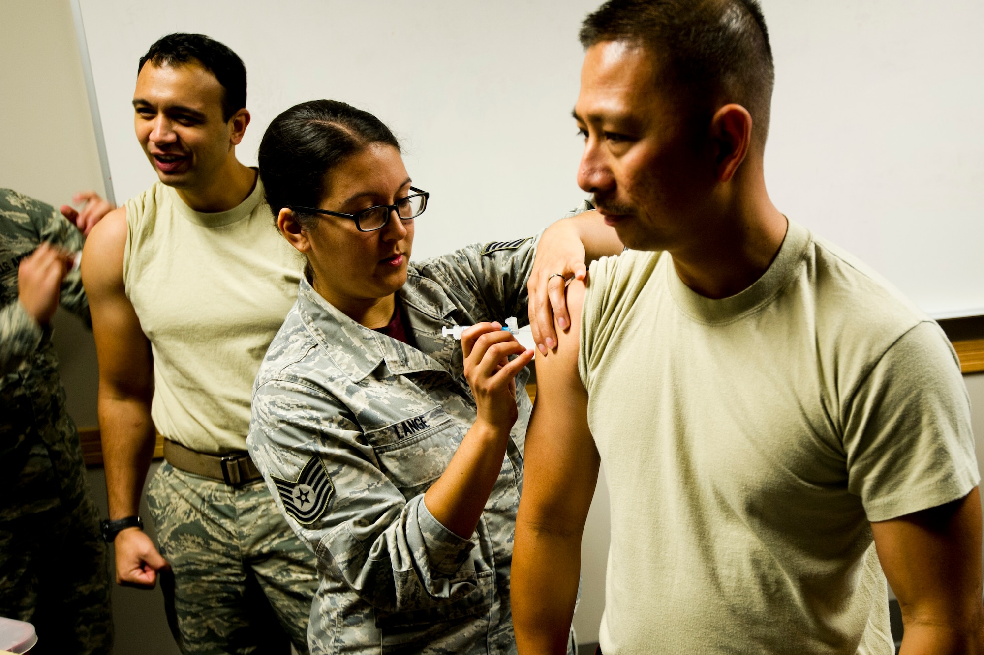 TSgt. Sherlly Lange, 446th Aerospace Medicine Squadron, administers a flue shot to Airmen from the 446th Airlift Wing on McChord Field, Oct. 17.  The AMDS will be administering flu shots during Unit Training Assemblies October through December this season at multiple sites around the base. (U.S. Air Force Reserve photo by SrA Daniel Liddicoet)
