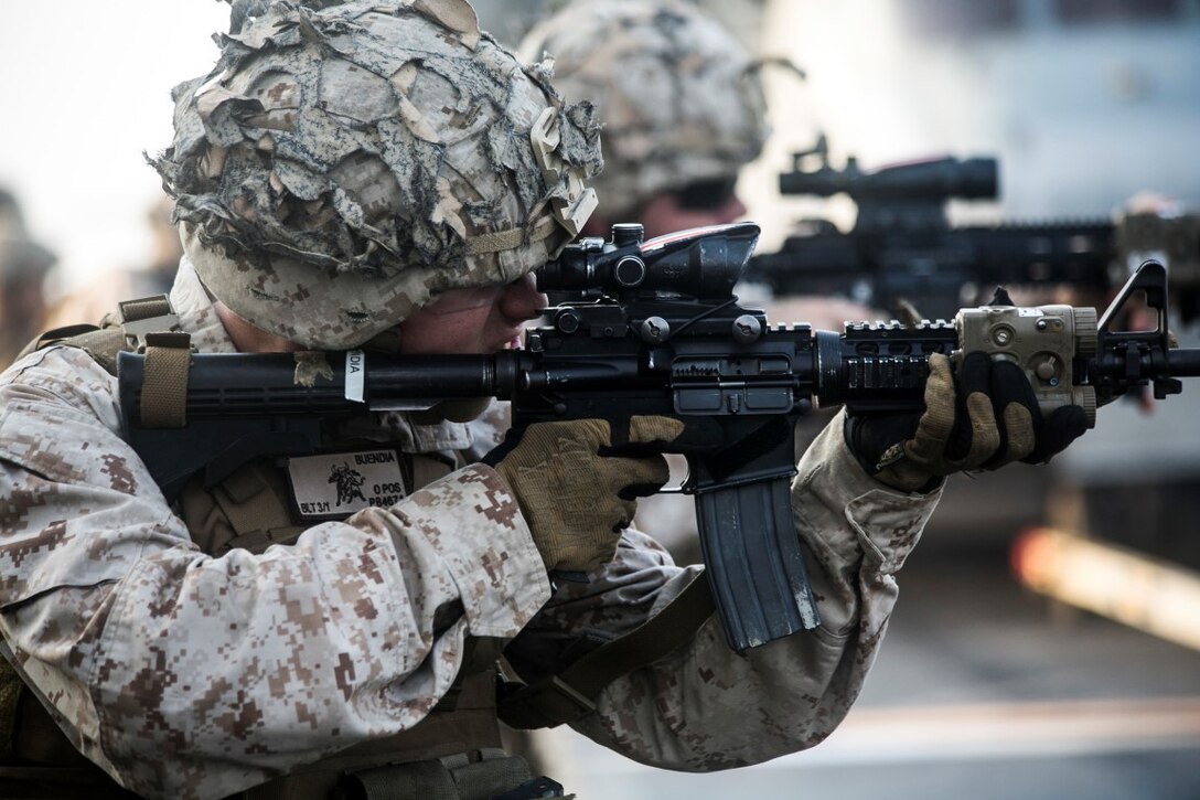 ARABIAN GULF (Oct. 16, 2015) A U.S. Marine with Lima Company, Battalion Landing Team 3rd Battalion, 1st Marine Regiment, 15th Marine Expeditionary Unit, fires at his target during a deck shoot aboard the amphibious assault ship USS Essex (LHD 2). The Marines grappled and ran between courses of fire to practice shooting with an increased heart rate. The 15th MEU, embarked aboard the ships of the Essex Amphibious Ready Group, is deployed to maintain regional security in the U.S. 5th Fleet area of operations. (U.S. Marine Corps photo by Cpl. Anna Albrecht/Released)