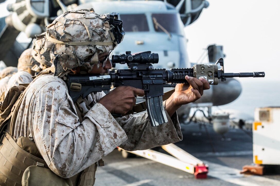 ARABIAN GULF (Oct. 16, 2015) A U.S. Marine with Lima Company, Battalion Landing Team 3rd Battalion, 1st Marine Regiment, 15th Marine Expeditionary Unit, fires at his target during a deck shoot aboard the amphibious assault ship USS Essex (LHD 2). The Marines grappled and ran between courses of fire to practice shooting with an increased heart rate. The 15th MEU, embarked aboard the ships of the Essex Amphibious Ready Group, is deployed to maintain regional security in the U.S. 5th Fleet area of operations. (U.S. Marine Corps photo by Cpl. Anna Albrecht/Released)