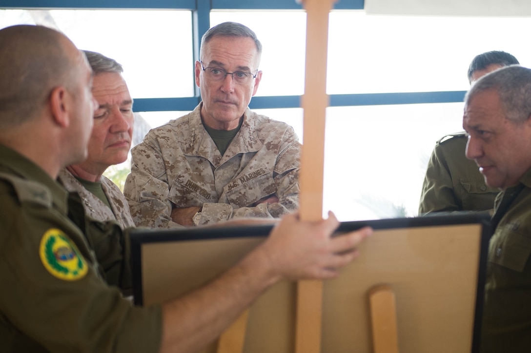 U.S. Marine Corps Gen. Joseph F. Dunford Jr., chairman of the Joint Chiefs of Staff, receives a brief prior to flying to northern Israel, Oct. 18, 2015. DoD photo by D. Myles Cullen