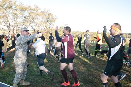 COATESVILLE, Penn. - U.S. Army Reserve Soldiers encourage Tough Mudders as they begin the Tough Mudder Philly course in Coatesville, Penn., Oct. 18. The U.S. Army Reserve was one of the sponsors for the event.(U.S. Army photo by Staff Sgt. Debralee Best)