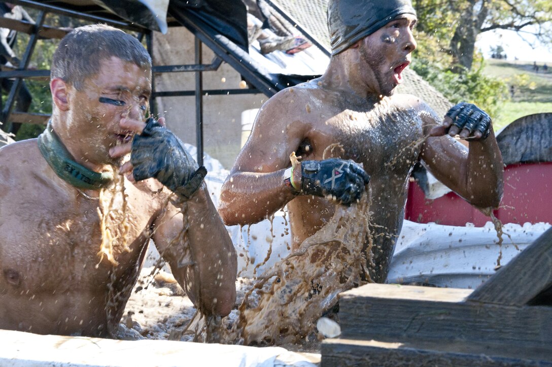 COATESVILLE, Penn. - Tough Mudders come up from the icy water of the Arctic Enema during the Tough Mudder Philly course in Coatesville, Penn., Oct. 18. The U.S. Army Reserve was one of the sponsors for the event.(U.S. Army photo by Staff Sgt. Debralee Best)