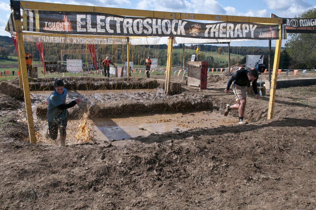 COATESVILLE, Penn. - Tough Mudders run through the final obstacle of the Tough Mudder Philly course, the Electroshock, in Coatesville, Penn., Oct. 18. The U.S. Army Reserve was one of the sponsors for the event.(U.S. Army photo by Staff Sgt. Debralee Best)