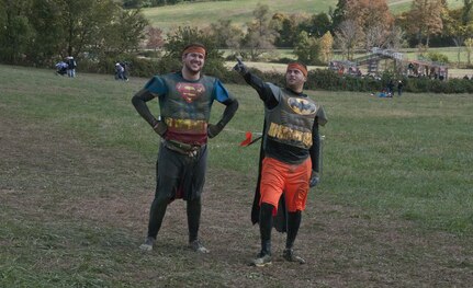 COATESVILLE, Penn. - A Superman and Batman Tough Mudder pose while running the final stretch of the Tough Mudder Philly course in Coatesville, Penn., Oct. 18. The U.S. Army Reserve was one of the sponsors for the event.(U.S. Army photo by Staff Sgt. Debralee Best)