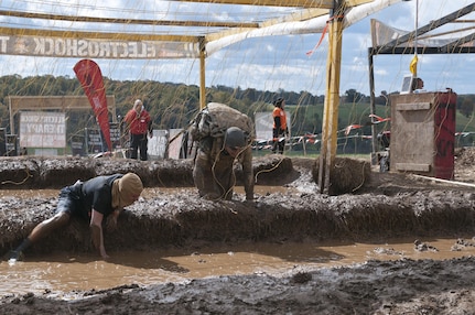 COATESVILLE, Penn. - U.S. Army Reserve Spc. Aaron Haun (right), motor transport operator, 223rd Transportation Company and Lancaster, Penn., resident, runs through the final obstacle of the Tough Mudder Philly course, the Electroshock, in Coatesville, Penn., Oct. 18. The U.S. Army Reserve was one of the sponsors for the event.(U.S. Army photo by Staff Sgt. Debralee Best)