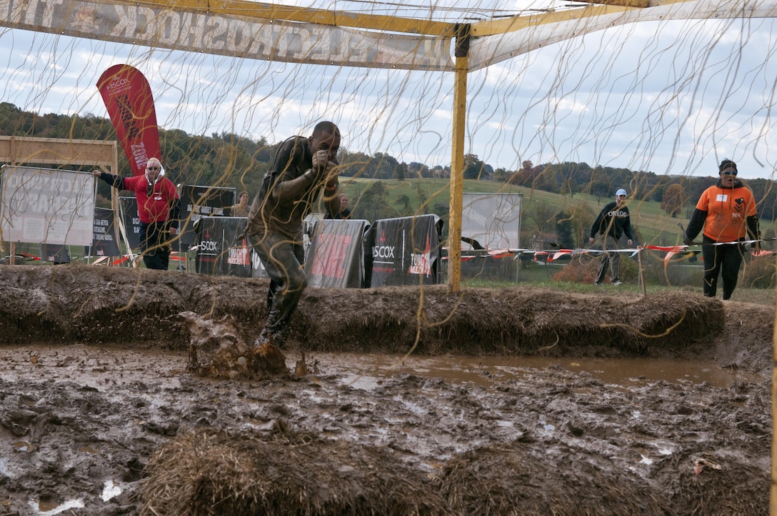 COATESVILLE, Penn. - U.S. Army Reserve Spc. Christopher Washington, motor transport operator, 223rd Transportation Company and Norriton, Penn., resident, runs through the final obstacle of the Tough Mudder Philly course, the Electroshock, in Coatesville, Penn., Oct. 18. The U.S. Army Reserve was one of the sponsors for the event.(U.S. Army photo by Staff Sgt. Debralee Best)