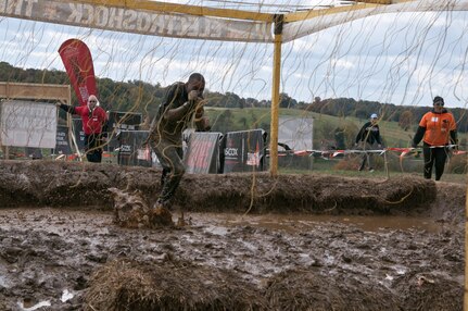 COATESVILLE, Penn. - U.S. Army Reserve Spc. Christopher Washington, motor transport operator, 223rd Transportation Company and Norriton, Penn., resident, runs through the final obstacle of the Tough Mudder Philly course, the Electroshock, in Coatesville, Penn., Oct. 18. The U.S. Army Reserve was one of the sponsors for the event.(U.S. Army photo by Staff Sgt. Debralee Best)