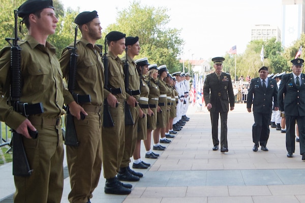 U.S. Marine Corps Gen. Joseph F. Dunford Jr., chairman of the Joint Chiefs of Staff, walks with Israeli officials past the Israeli Defense Forces honor guard during an official welcome ceremony at the IDF headquarters in Tel Aviv, Israel, Oct. 18, 2015. DoD photo by D. Myles Cullen