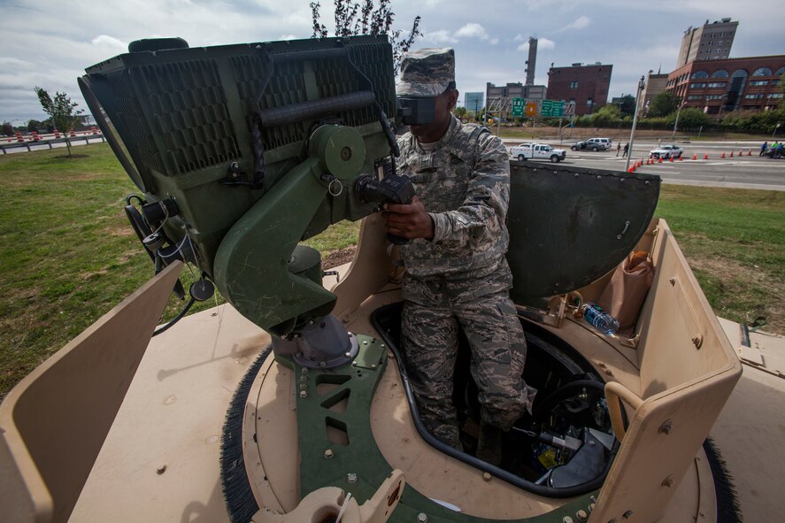 Airman Khari Baynes, 108th Wing, New Jersey Air National Guard, peers through a long range advanced scout surveillance system near the Benjamin Franklin Bridge, located between Camden, N.J., and Philadelphia, Sept. 27, 2015. The joint New Jersey National Guard task force comprised of Soldiers with the 1st Squadron, 102nd Cavalry, and 108th Wing Airmen are assisting New Jersey civil authorities and the Delaware Port Authority with security during Pope Francis’s visit to Philadelphia Sept. 26-27. (U.S. Air National Guard photo by Master Sgt. Mark C. Olsen/Released)