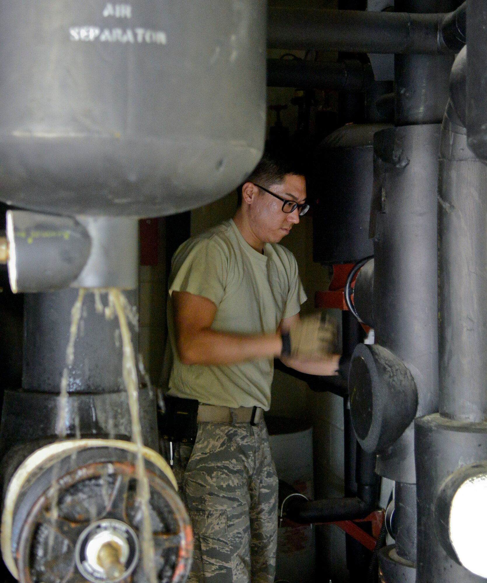 Staff Sgt. Seung Taek Lee, the 51st Civil Engineer Squadron heating, ventilation and air conditioning technician, empties water from the HVAC system in a building on Osan Air Base, Republic of Korea, Oct. 14, 2015. The water is emptied from the pipes during the No Heat/No Cool season to prevent pipes from freezing in upcoming winter months. (U.S. Air Force photo/Senior Airman Kristin High)