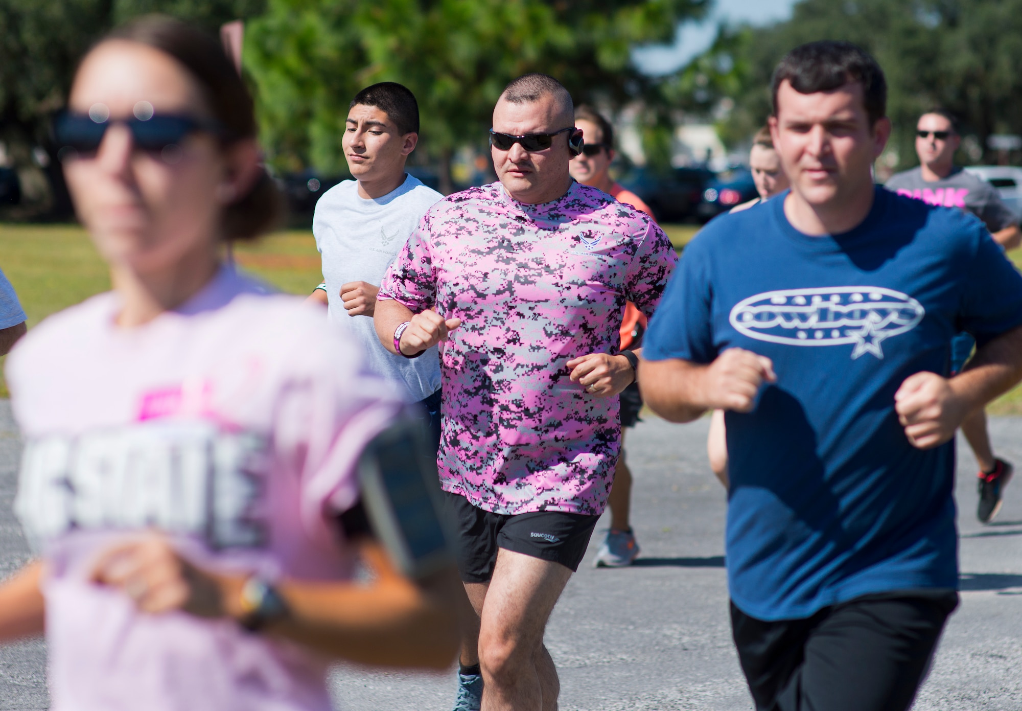 A runner wears an Air Force pink camo t-shirt to support the Eighth Annual Breast Cancer Awareness 5k run Oct. 17 at Eglin Air Force Base, Fla.  Eglin's health promotion flight was also on hand providing information on breast cancer risk factors, symptoms and screenings. The event was held to promote breast cancer awareness and the importance of self-examination to catch the disease in its early stages. More than 200 supporters came out to run.  (U.S. Air Force photo/Samuel King Jr.)