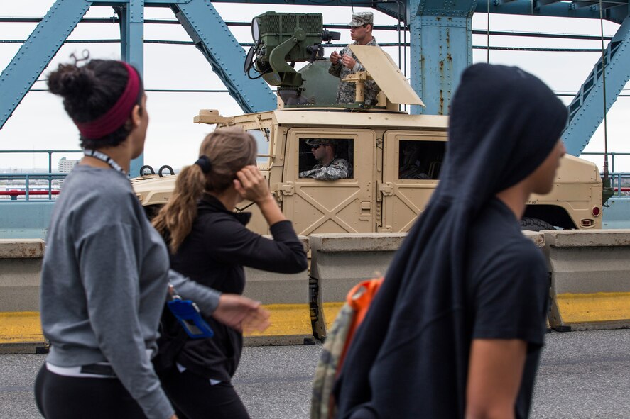 New Jersey National Guard Soldiers and Airmen provide security on the Benjamin Franklin Bridge, located between Camden, N.J., and Philadelphia, as pedestrians cross from Camden, N.J., to Philadelphia for the Mass led by Pope Francis Sept. 27, 2015 The joint New Jersey National Guard task force comprised of Soldiers with the 1st Squadron, 102nd Cavalry, and Airmen from the 108th Wing are assisting New Jersey civil authorities and the Delaware Port Authority with security during Pope Francis’s visit to Philadelphia Sept. 26-27. (U.S. Air National Guard photo by Master Sgt. Mark C. Olsen/Released)