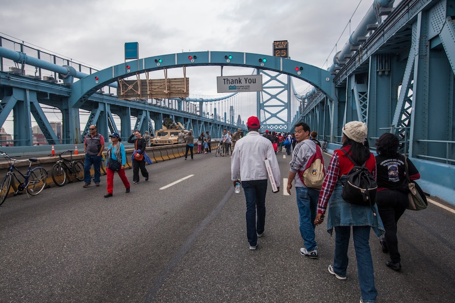 New Jersey National Guard Airmen and Soldiers provide security on the Benjamin Franklin Bridge, located between Camden, N.J., and Philadelphia, as pedestrians cross from Camden, N.J., to Philadelphia for the Mass led by Pope Francis Sept. 27, 2015 The joint New Jersey National Guard task force comprised of Soldiers with the 1st Squadron, 102nd Cavalry, and Airmen from the 108th Wing are assisting New Jersey civil authorities and the Delaware Port Authority with security during Pope Francis’s visit to Philadelphia Sept. 26-27. (U.S. Air National Guard photo by Master Sgt. Mark C. Olsen/Released)