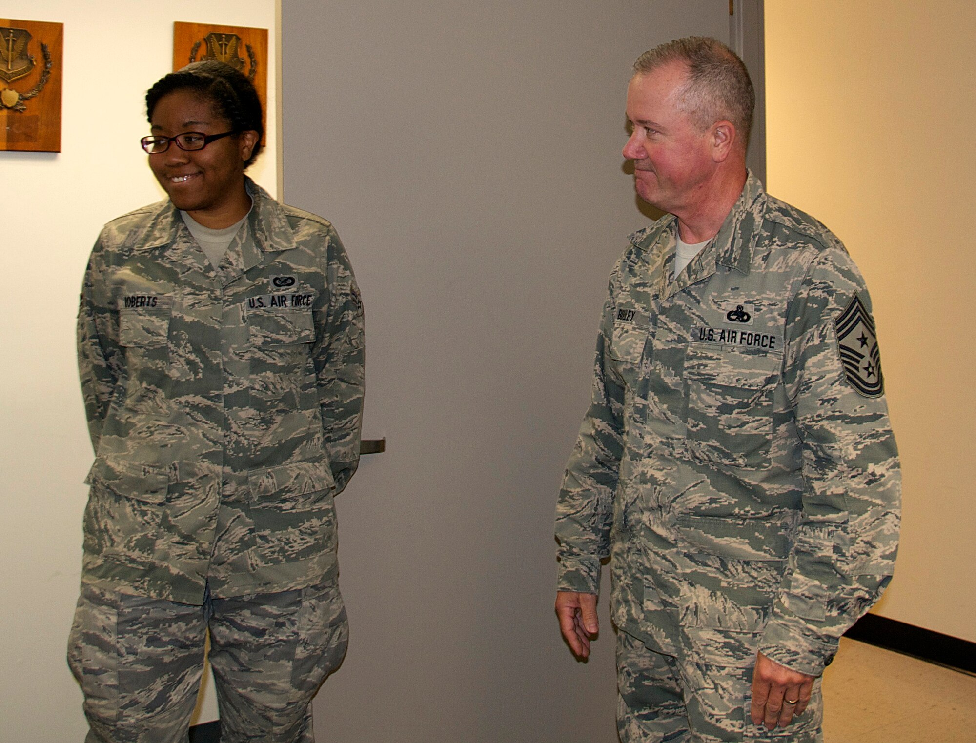 Senior Airman Johnisa B. Roberts, 192nd Fighter Wing Public Affairs photojournalist, received an outstanding performance chip from Command Chief Master Sgt. Michael J. Bouley, 192nd FW command chief, September 13, 2015 at Joint Base Langley-Eustis, Virginia. Chief Bouley coined (“chipped”) Roberts to recognize her for obtaining her Bachelor’s degree in Mathematics, May 2015 from Christopher Newport University in Newport News, Virginia. Roberts is currently continuing her education at CNU as part of a five-year program to obtain her Master’s in the Arts of Teaching. (U.S. Air National Guard photo by Master Sgt. Carlos J. Claudio/Released)