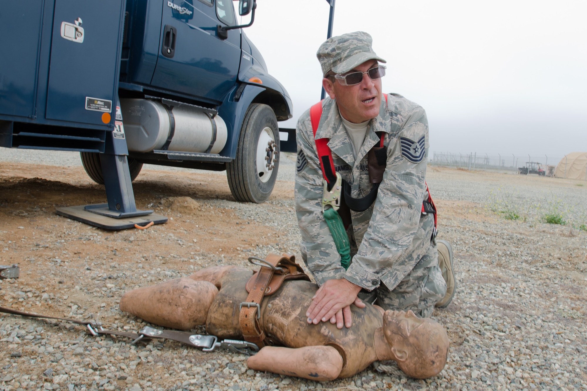 Tech Sgt. Monty Williams, an electrician for the Kentucky Air National Guard’s 123rd Civil Engineer Squadron, performs CPR on a dummy during a training scenario at March Air Reserve Base, Calif., on June 11, 2015. The exercise was designed to simulate a real-world mission. (U.S. Air National Guard photo by Senior Airman Joshua Horton)