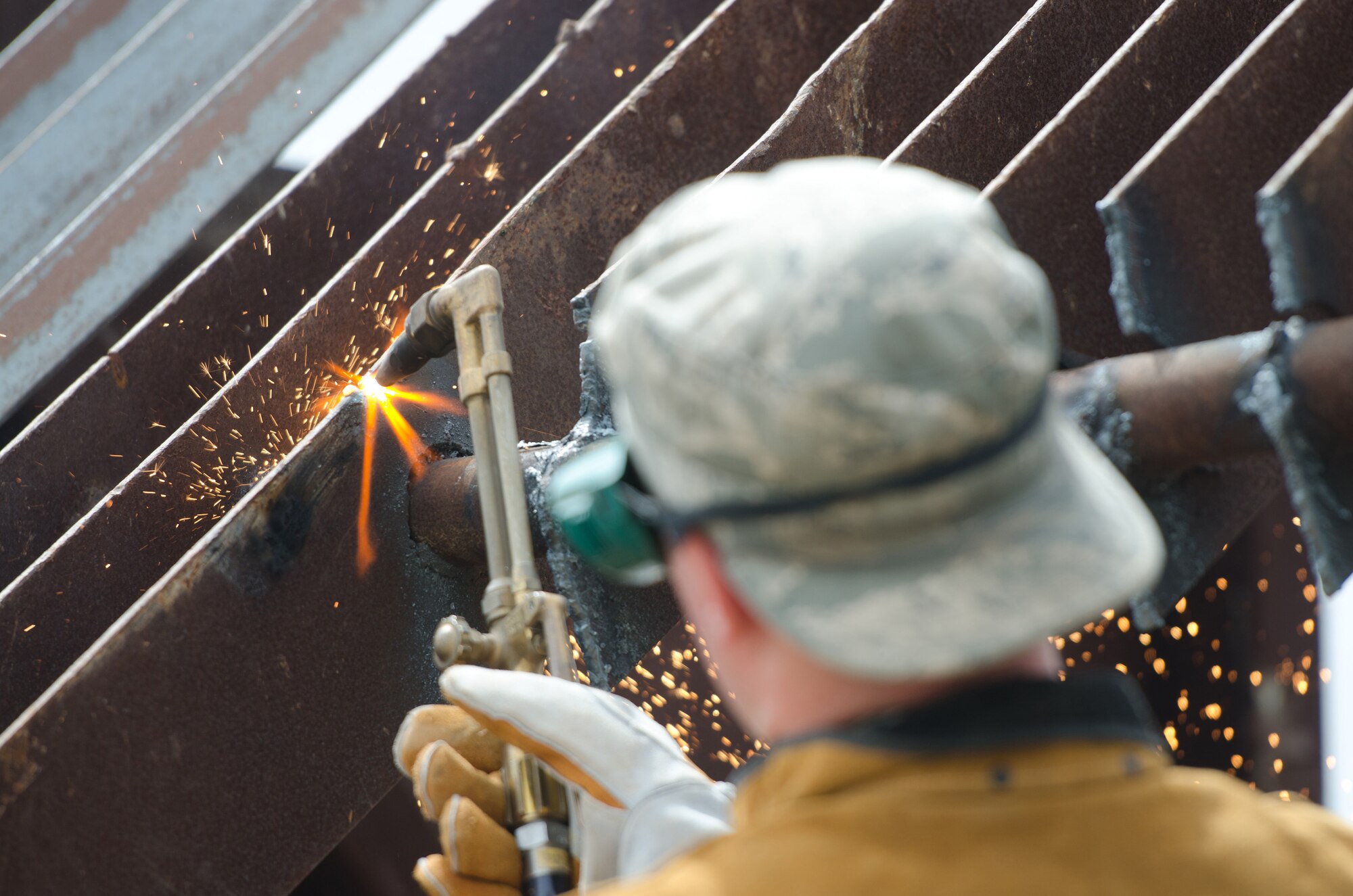 Senior Airman Charles Fredrick, a carpenter in the structures section of the Kentucky Air National Guard’s 123rd Civil Engineer Squadron, cuts metal during a training scenario at March Air Reserve Base, Calif., on June 11, 2015. The exercise was designed to simulate a real-world mission. (U.S. Air National Guard photo by Senior Airman Joshua Horton)