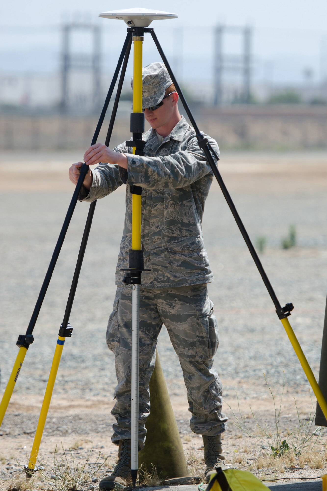 Staff Sgt. Daniel Brooks, an engineer for the Kentucky Air National Guard’s 123rd Civil Engineer Squadron, sets up surveying equipment during a training scenario at March Air Reserve Base, Calif., on June 10, 2015. The exercise was designed to simulate a real-world mission. (U.S. Air National Guard photo by Senior Airman Joshua Horton)