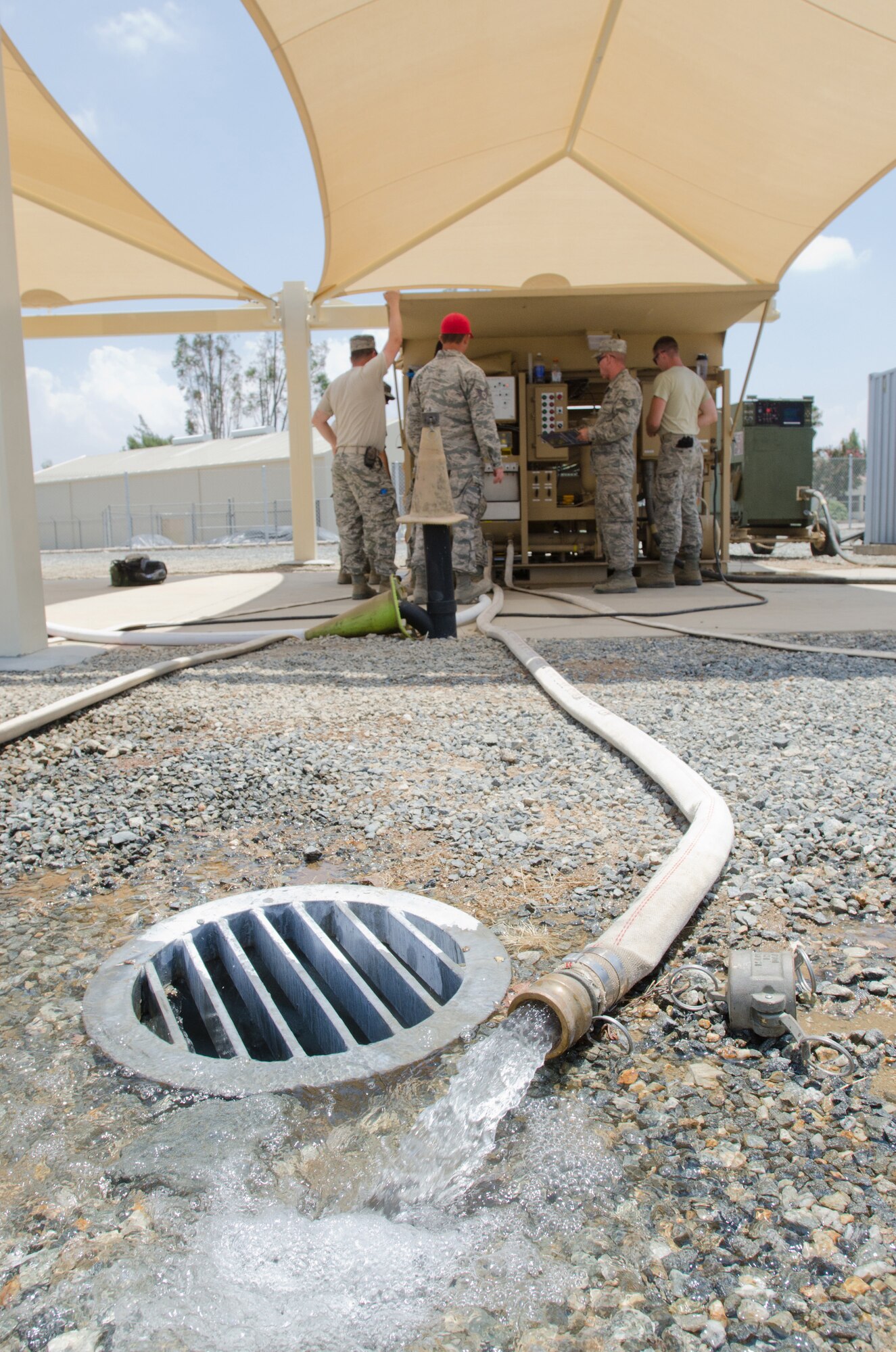 Members of the utilities shop in the Kentucky Air National Guard’s 123rd Civil Engineer Squadron utilize a reverse-osmosis water purification unit during a training scenario at March Air Reserve Base, Calif., on June 10, 2015. The exercise was designed to simulate a real-world mission. (U.S. Air National Guard photo by Senior Airman Joshua Horton)