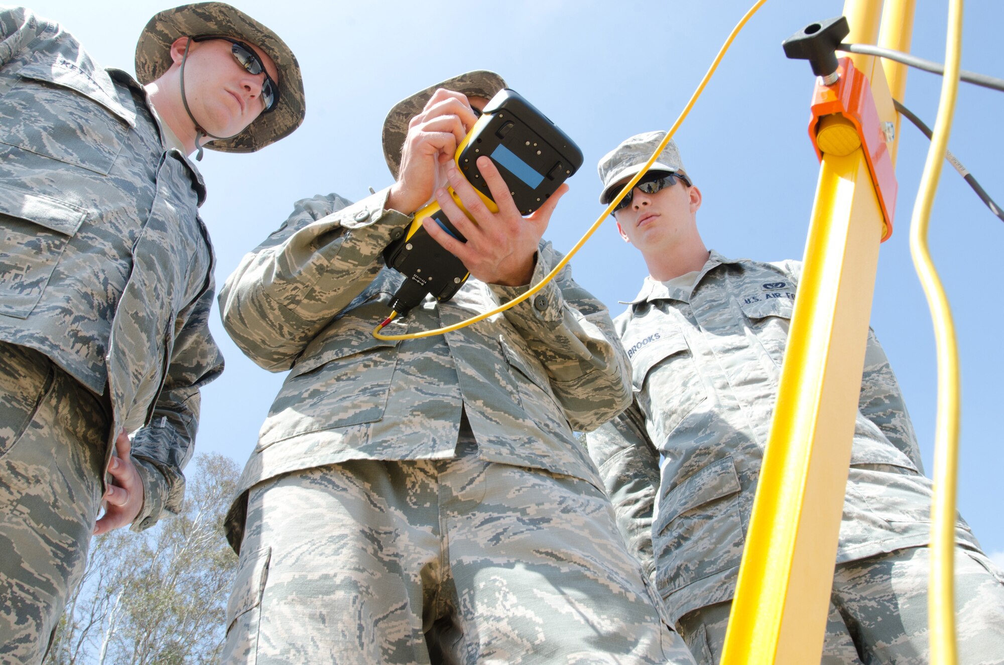 Tech Sgt. Nick Ketterer (left), Staff Sgt. Abe Hilbers (middle) and Staff Sgt. Daniel Brooks (right), all engineers for the Kentucky Air National Guard’s 123rd Civil Engineer Squadron, utilize surveying equipment during a training scenario at March Air Reserve Base, Calif., on June 10, 2015. The exercise was designed to simulate a real-world mission. (U.S. Air National Guard photo by Senior Airman Joshua Horton)