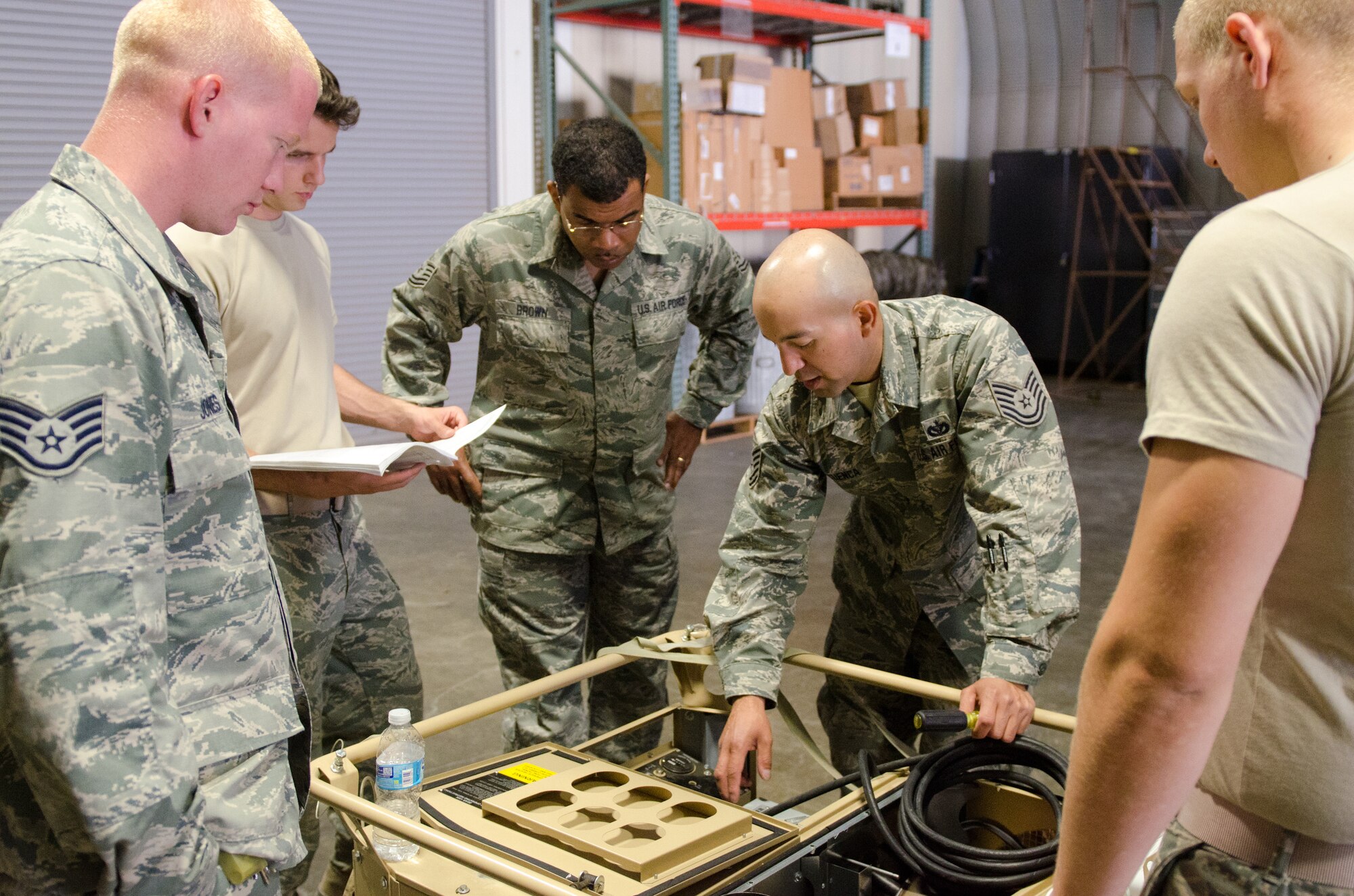 Heating, Ventilation and Air Conditioning technicians from the Kentucky Air National Guard’s 123rd Civil Engineer Squadron receive guidance from a cadre member during a training scenario at March Air Reserve Base, Calif., on June 9, 2015. The Airmen were participating in a week-long exercise designed to simulate real-world missions. (U.S. Air National Guard photo by Senior Airman Joshua Horton)