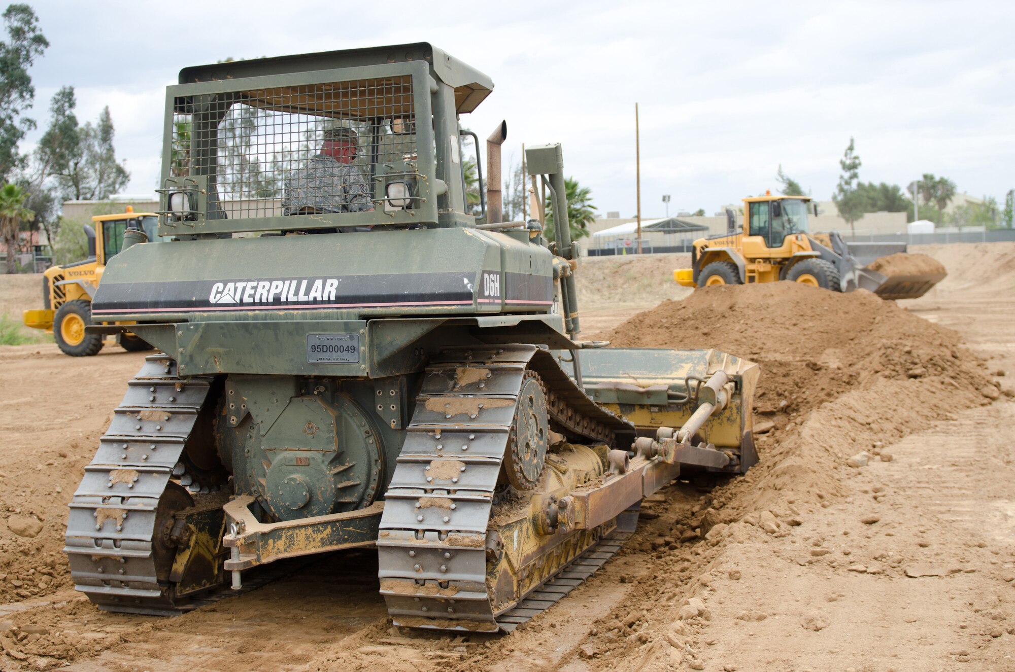 Members of the pavements and grounds shop of the Kentucky Air National Guard’s 123rd Civil Engineer Squadron operate heavy equipment during a training scenario at March Air Reserve Base, Calif., on June 9, 2015. The exercise was designed to simulate a real-world mission. (U.S. Air National Guard photo by Senior Airman Joshua Horton)