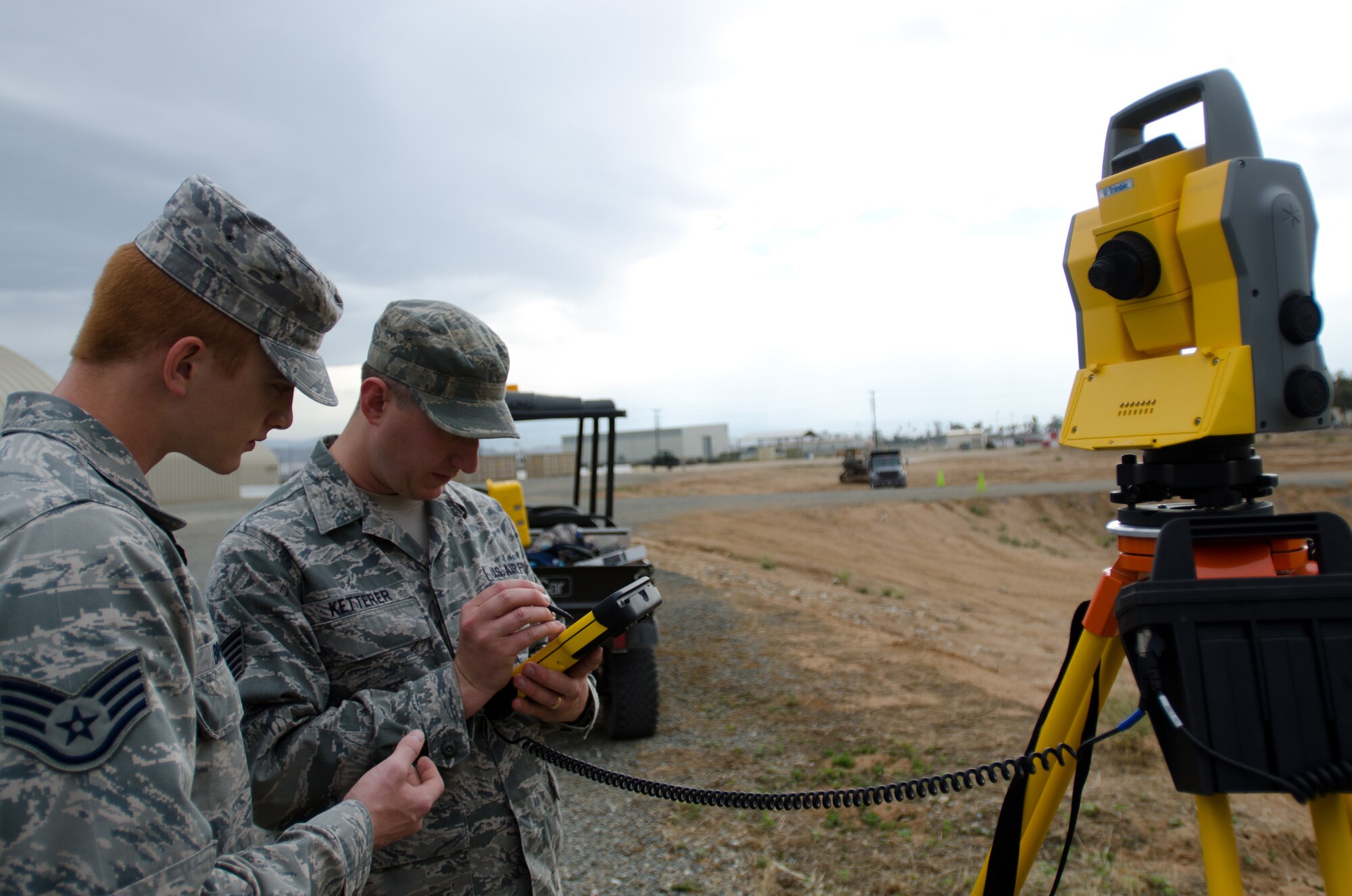 Staff Sgt. Daniel Brooks (left) and Tech Sgt. Nick Ketterer of the Kentucky Air National Guard’s 123rd Civil Engineer Squadron train with surveying equipment during an exercise at March Air Reserve Base, Calif., June 9, 2015. The exercise was designed to simulate a real-world mission. (U.S. Air National Guard photo by Senior Airman Joshua Horton)