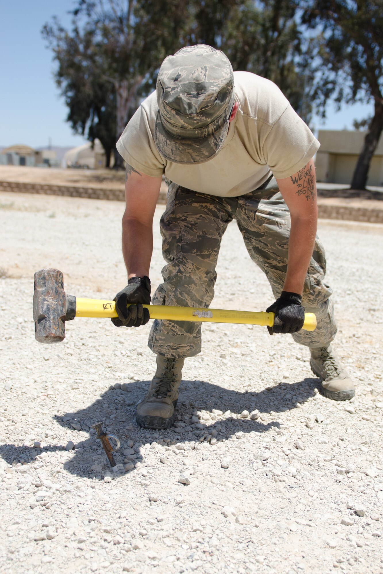 Senior Airman Charles Fredrick, a carpenter in the structures section of the Kentucky Air National Guard’s 123rd Civil Engineer Squadron, drives tent stakes during a training scenario at March Air Reserve Base, Calif, on June 8, 2015. The exercise was designed to simulate a real-world mission. (U.S. Air National Guard photo by Senior Airman Joshua Horton)
