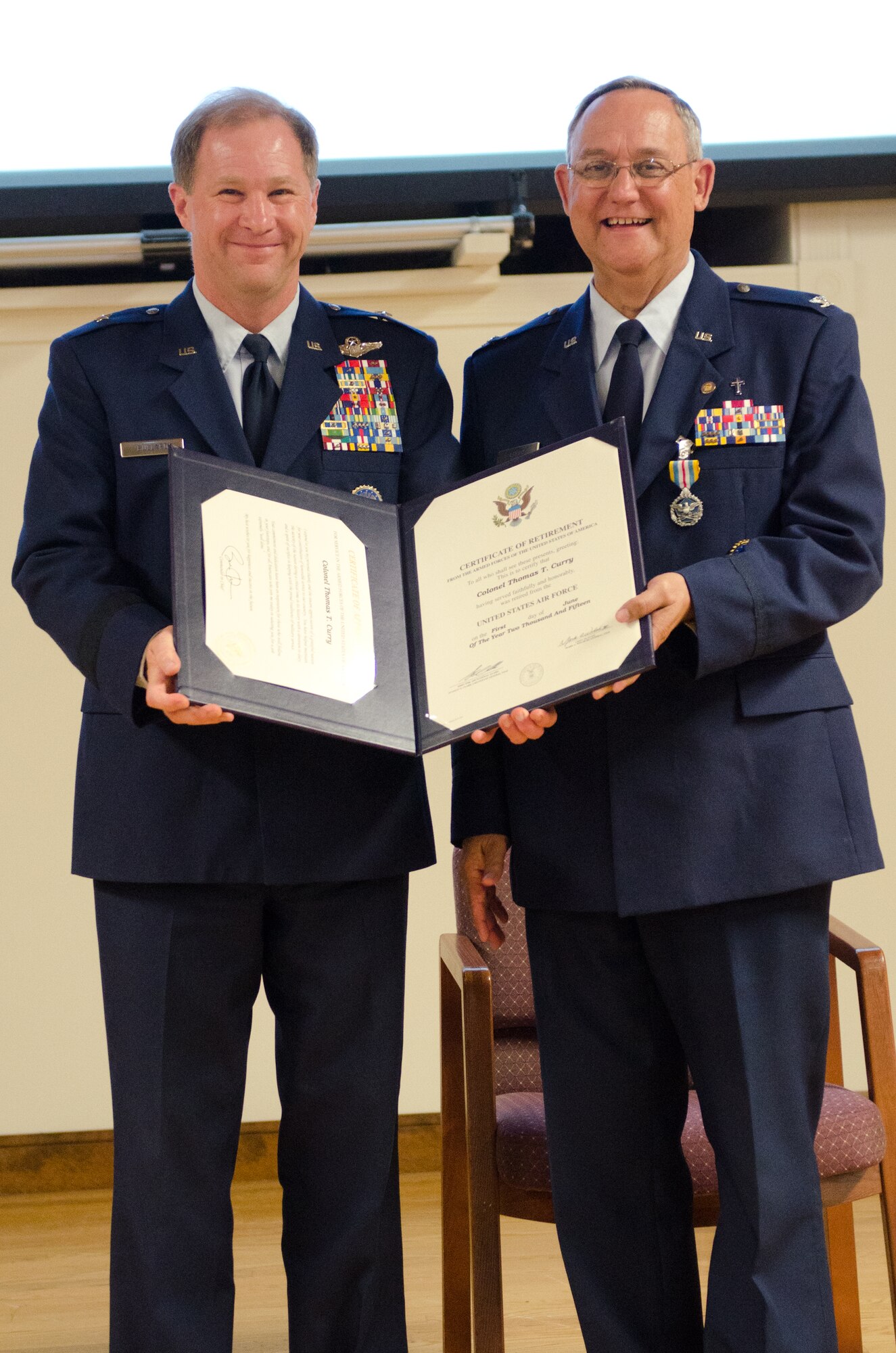 Brig. Gen. Steven P. Bullard (left), the chief of staff for Headquarters, Kentucky Air National Guard, presents Chaplain (Col.) Thomas Curry, the outgoing Air National Guard assistant to command chaplain for NORAD and USNORTHCOM, with Curry’s certificate of retirement during a ceremony at the Kentucky Air National Guard Base in Louisville, Ky. on June 6, 2015.  Curry is retiring after more than three decades of service to the Kentucky Air National Guard. (U.S. Air National Guard photo by Senior Airman Joshua Horton)