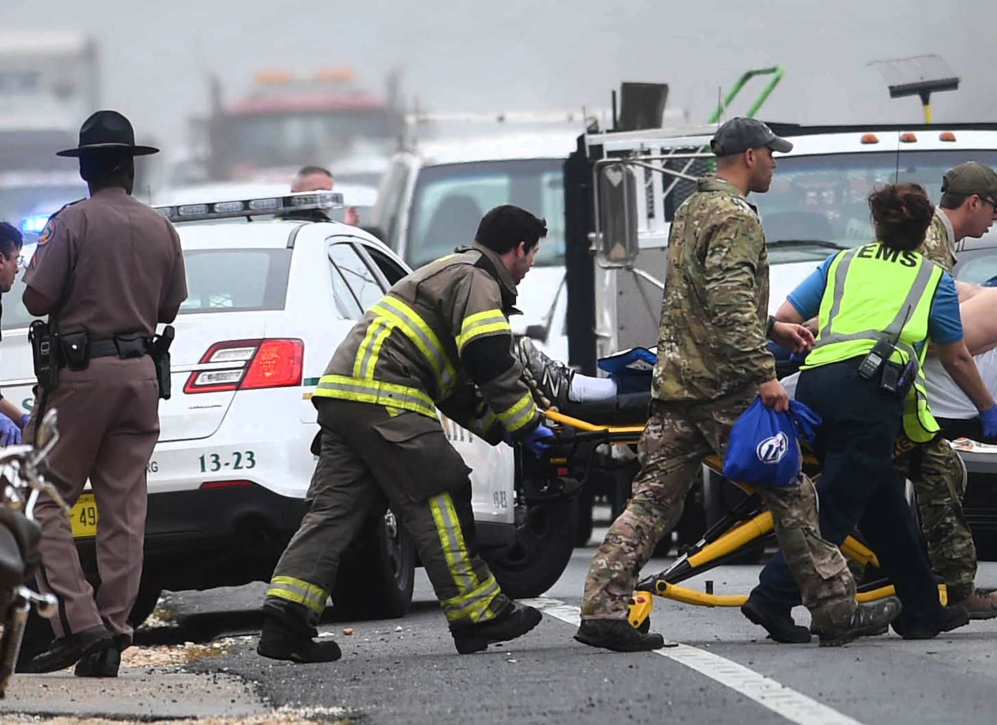 A pararescue Airman from the Kentucky Air National Guard’s 123rd Special Tactics Squadron assists an injured motorist following a traffic accident in Florosa, Fla., March 3, 2015. The Airman was later recognized with a Community Service Award from the Okaloosa Country Sheriff’s Department for his actions. (Photo by Nick Tomecek, Northwest Florida Daily News)