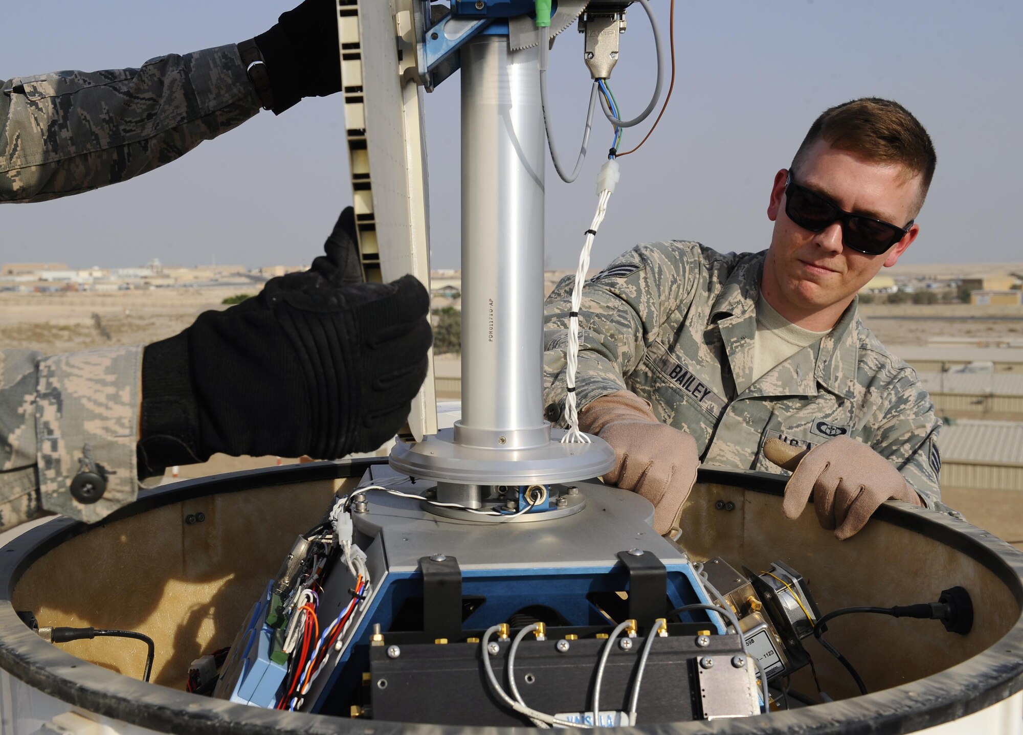 U.S. Air Force Senior Airman David Baily, 386th 386th Expeditionary Operations Support Squadron weather forecaster, inspects a Doppler radar system at an undisclosed location in Southwest Asia, Oct. 16, 2015. The radar system determines air density, information which forecasters then relay to aircraft supporting Operation INHERENT RESOLVE to ensure mission success. (U.S. Air Force photo by Staff Sgt. Tyler Alexander/Released)