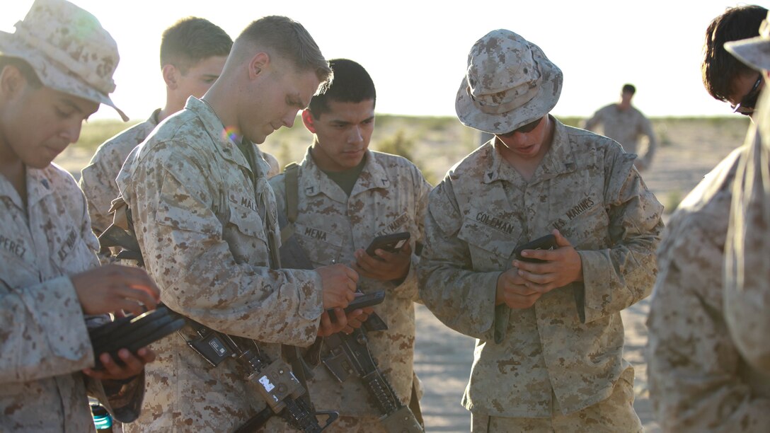 Marines with Fox Company, 2nd Battalion, 7th Marine Regiment use tablets to help them in a training exercise at Marine Corps Air Station Yuma, Arizona, Oct. 14, 2015. The tablets are wirelessly connected through an encrypted internal Wi-Fi network allowing Marines to coordinate and maneuver more efficiently in a tactical environment while securely using various applications on the devices.