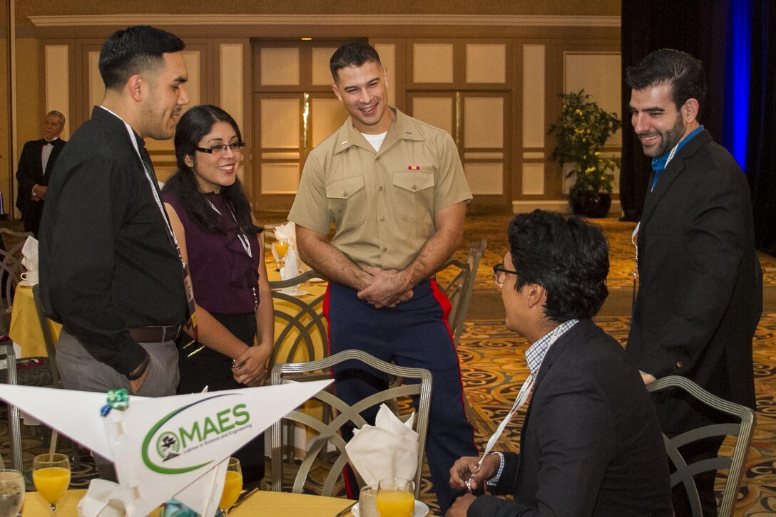 Second Lieutenant Kris Elliot discusses a story with attendees of the Chapter Officer’s Breakfast hosted by the Marines at the 2015 MAES: Latinos in Science and Engineering Symposium in Las Vegas, October 15, 2015. Investing in a diverse and representative officer corps will help generate and sustain a future force that has the cultural expertise, language skill sets and a variety of philosophies needed to meet the operational requirements of the Marine Corps. Elliot serves as an air support control officer with Marine Air Support Squadron-6 at Marine Corps Air Station Miramar, California.