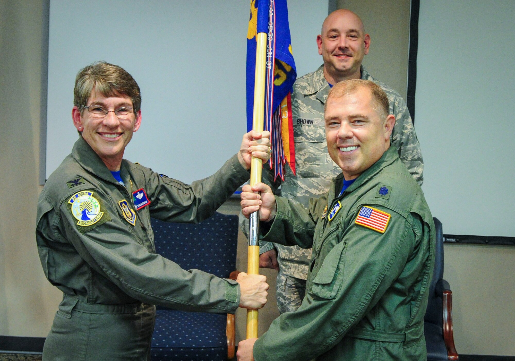 Lt. Col. Mark Johnson receives the 300th Airlift Squadron guidon and assumes command from Col. Caroline Evernham, 315th Operations Group commander during the 300 AS Change of Command ceremony at Joint Base Charleston, S.C. October 17, 2015. 