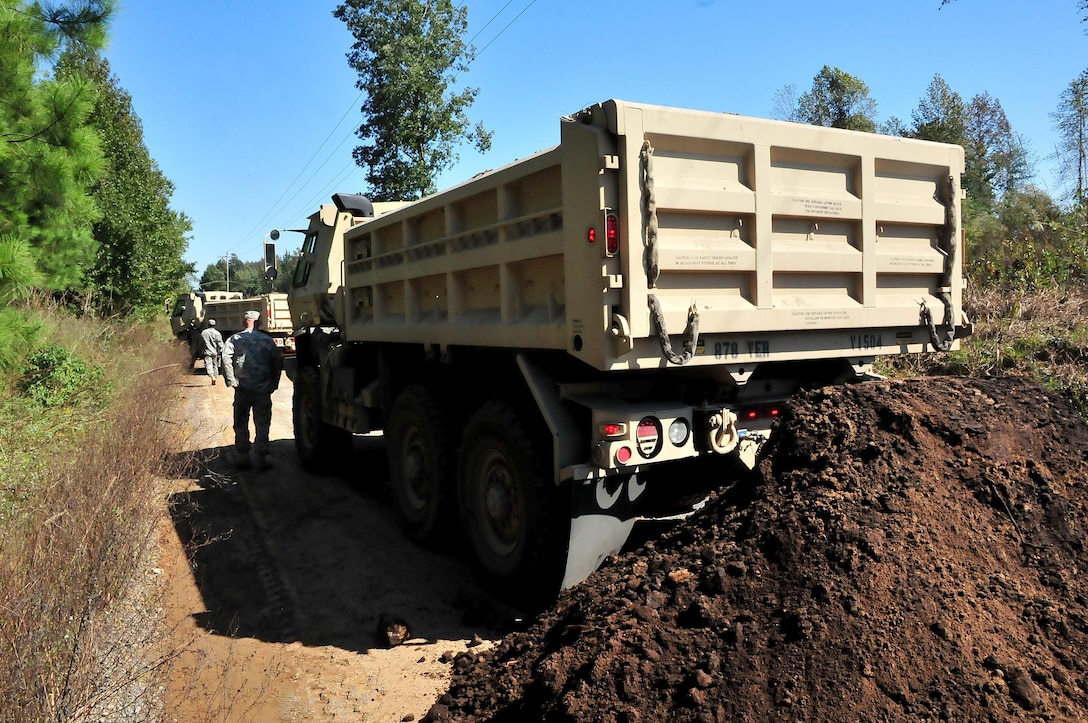 North Carolina Army National Guardsmen work to repair multiple sections of Indian Hut Road in Andrews, South Carolina, Oct. 16, 2015. North Carolina Army National Guard photo