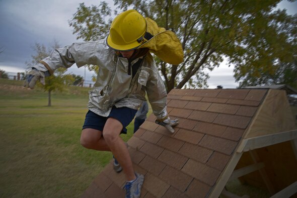 A U.S. Air Force Airman with the 27th Special Operations Support Squadron leaps over a wall as part of an obstacle course during the 16th Annual Squadron Fire Muster Oct. 16, 2015, at Cannon Air Force Base, N.M. Six teams from various squadrons across the 27th Special Operations Wing came together to compete in this year’s muster. (U.S. Air Force photo/Staff Sgt. Alexx Pons)