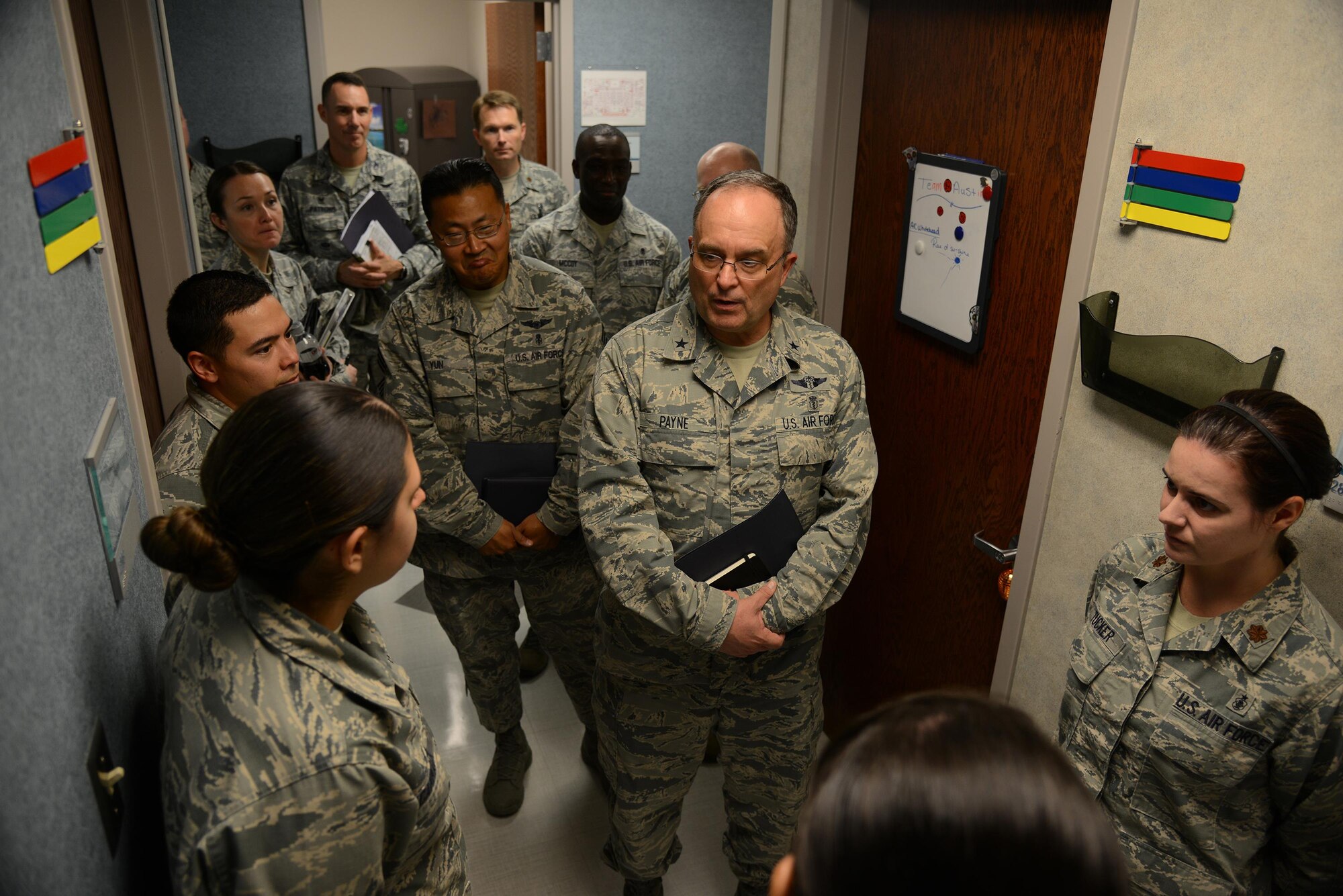 Airman 1st Class Mychaela Cammack, 47th Medical Operations Squadron pediatrics technician, bottom left, briefs Brig. Gen. (Dr.) Lee E. Payne, Air Force Medical Operations Agency commander, at the 47th Medical Group Clinic on Laughlin Air Force Base, Texas, Oct. 15, 2015. The pediatrics clinic was one of twelve units Payne visited during his visit to Laughlin to gain a better perspective of the mission and challenges faced by the unit. (U.S. Air Force photo by Tech Sgt. Steven R. Doty)(Released)