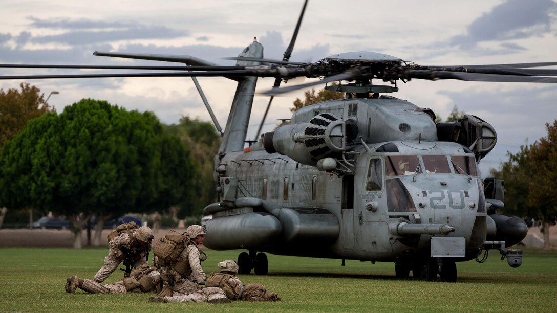 Marines with 2nd Battalion, 7th Marine Regiment, based out of Marine Corps Air Ground Combat Center Twentynine Palms, Calif., provide security in front of a CH-53E Super Stallion helicopter during a non-combatant evacuation exercise at Kiwanis Park in Yuma, Ariz., Friday, Oct. 16, 2015. The Marines reinforced initial ground units preparing for the evacuation.