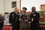 DLA Distribution commander Army Brig. Gen. Richard Dix, on right, and Deputy Commanding General, National Guard Army Brig. Gen. John King, left, present veteran Army Sgt. Earnest Felton Jett, Sr., with medals and badges for his service in World War II.