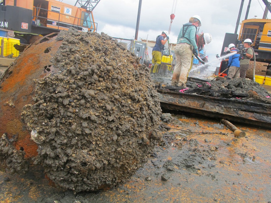 Archaeologists with Panamerican Consultants, Inc. spray down pieces of the CSS Georgia’s armor or “casemate” during the mechanized recovery phase, Sept. 24. The mechanized recovery is one of the final phases of the project that will remove the ironclad before deepening the Savannah harbor. 
