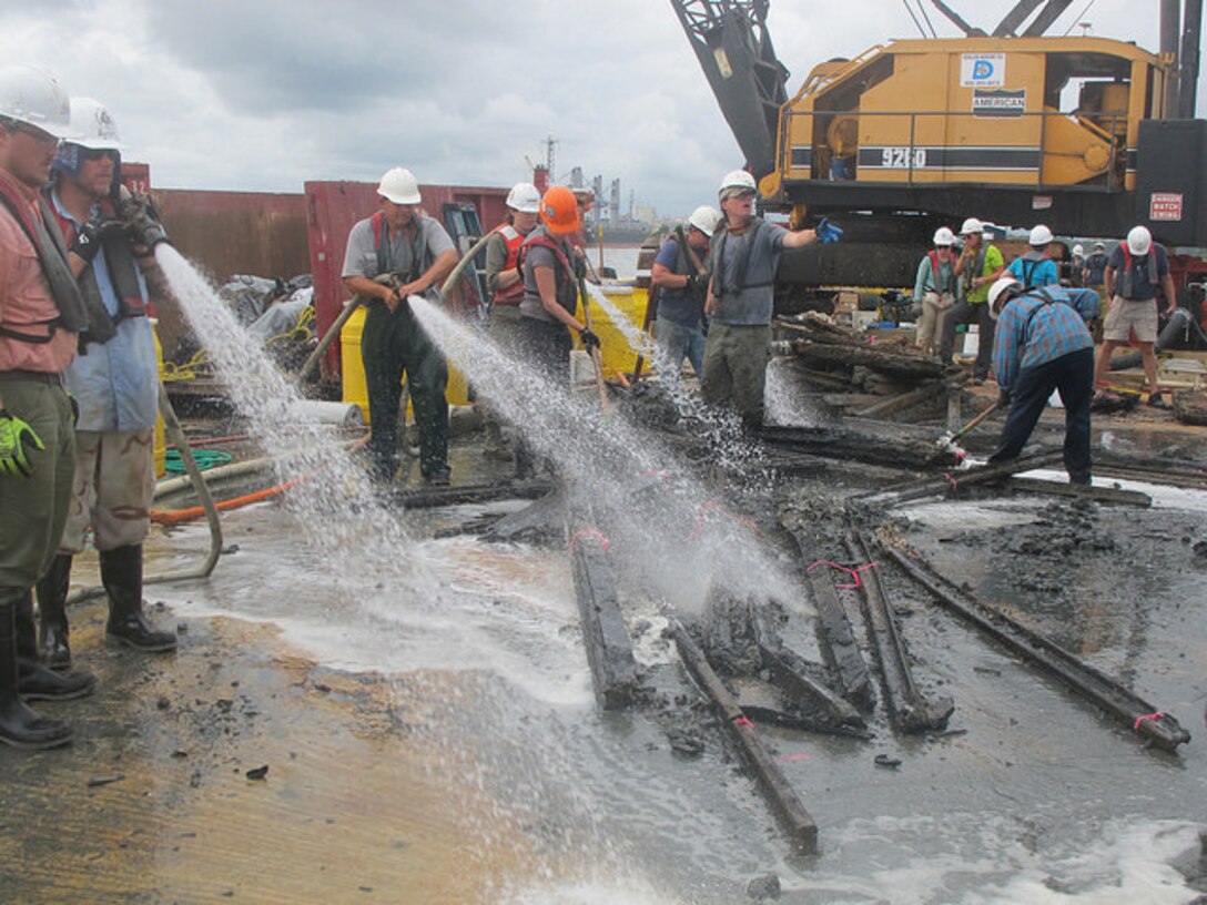 Archaeologists with Panamerican Consultants, Inc. spray down pieces of the CSS Georgia’s armor or “casemate” during the mechanized recovery phase, Sept. 24. The mechanized recovery is one of the final phases of the project that will remove the ironclad before deepening the Savannah harbor. 